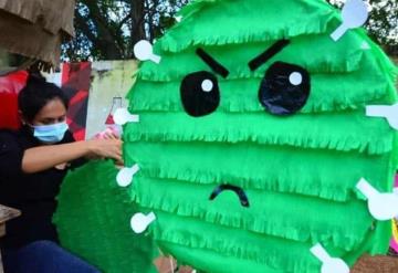 Foto del día: Mujer realiza piñatas del coronavirus en la Deportiva