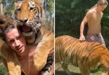 Joven le hace caballito a un tigre y arriesga su vida